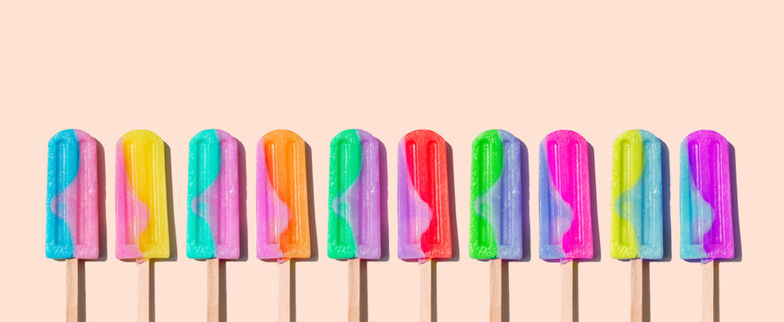 Row of rainbow-colored icecream lollies