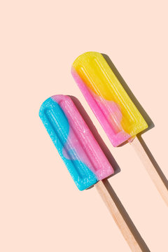 Two icecream lollies on a wooden stick