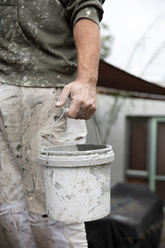 Painter at work on exterior of home in Australia
