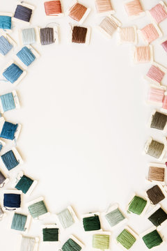 colorful embroidery thread on a white background with copy space