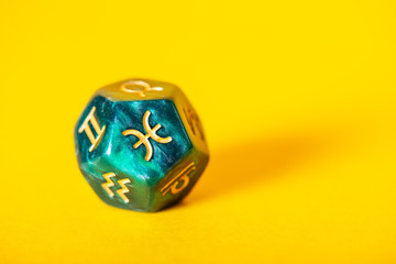 Astrology Dice with zodiac symbol of Pisces Feb 19 - Mar 20 on Yellow Background