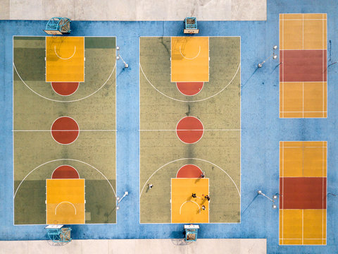 Group of people playing on a  basketball court