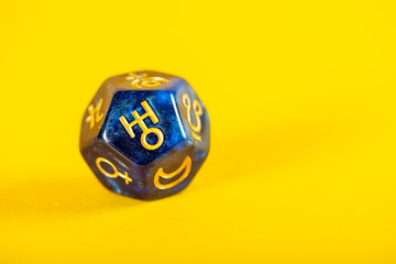 Astrology Dice with symbol of the planet Uranus on Yellow Background