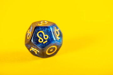Astrology Dice with symbol of Rahu on Yellow Background