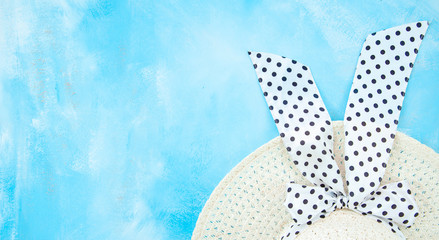 Summer background mockup. Women's summer straw hat on pastel blue background. Flat lay with copy space