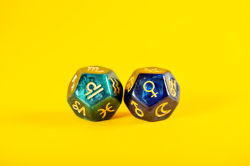 Astrology Dice with zodiac symbol of Libra Sep 23 - Oct 22 and its ruling planet Venus on Yellow...