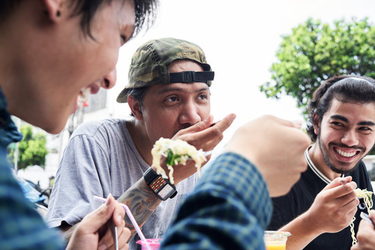 Best friends eating street food in summer.