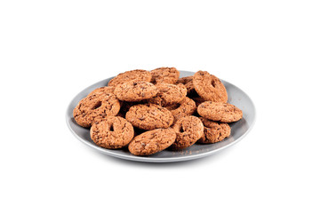 Fresh baked chocolate chip cookies heap on grey plate isolated on white.
