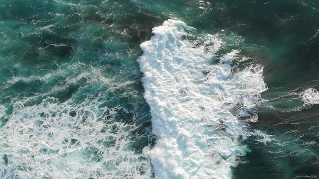 Aerial Drone Azores Portugal tilt down from mountains and sunset to waves in the sea sun flares