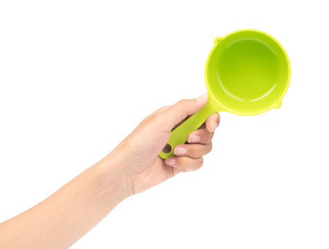 hand holding green plastic scoop isolated on white background