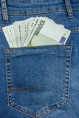 Close Up View to 100 Euro Banknotes Sticking Out From a Blue Jeans Pocket.