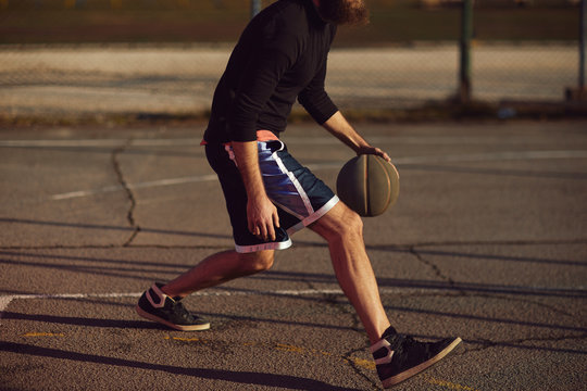 Closeup of basketball player on outdoor court.