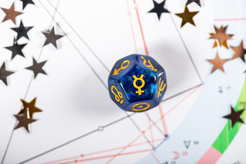 Astrology Dice with symbol of the planet Mercury on Natal Chart Background