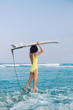 Unrecognizable surfer standing in sea