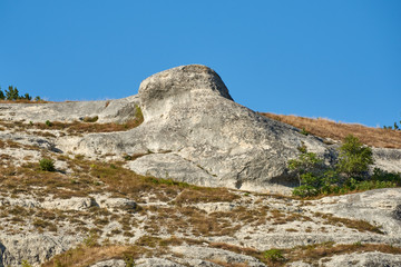 Fototapeta na wymiar Russia. Crimea. Bakhchisarai. Rock Frog crawling up the hill