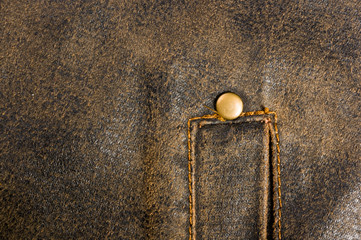 clothing items stonewashed cotton fabric texture with seams, clasps, buttons and rivets, macro