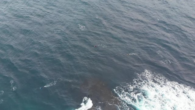 Aerial Drone tilt down to waves in ocean