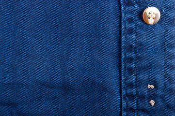 clothing items stonewashed cotton fabric texture with seams, clasps, buttons and rivets, macro