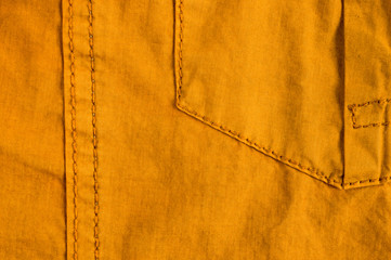 clothing items stonewashed cotton fabric texture with seams, clasps, buttons and rivets, macro
