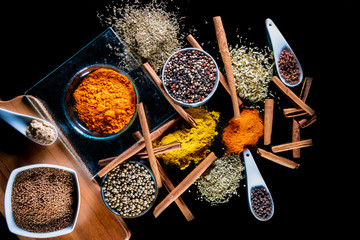 Culinary background with spices on black table