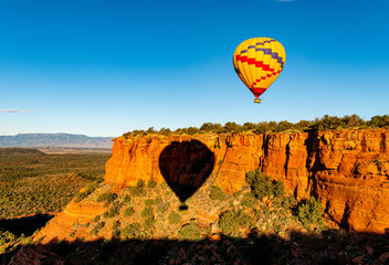 Hot air balloon ride over the bueatiful red rock cliffs of Sedona Arizona