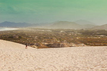 Woman looking at the horizon in the dunes of Florianopolis - SC.