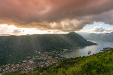 Bay of Kotor from the heights. View from Mount Lovcen to the bay. View down from the observation platform on the mountain Lovcen. Mountains and bay in Montenegro. The liner near the old town of Kotor.