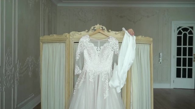 Bride undressing to put on her wedding dress