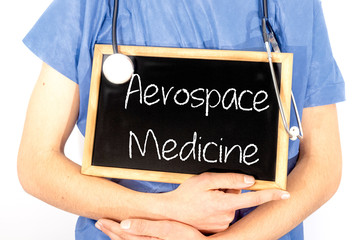 Doctor shows information on blackboard: aerospace medicine.  Medical concept.