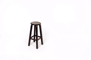 wooden chair on a white background. bar stool made of dark wood.