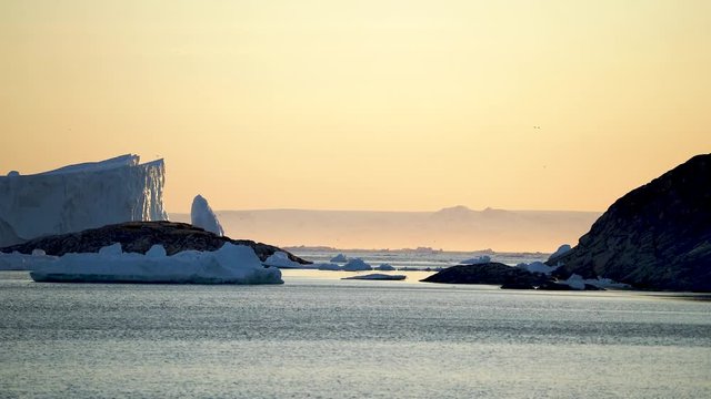 Sunset in Arctic Ocean on Icebergs