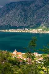 Fototapeta premium Bay of Kotor from the heights. View from Mount Lovcen to the bay. View down from the observation platform on the mountain Lovcen. Mountains and bay in Montenegro. The liner near the old town of Kotor.