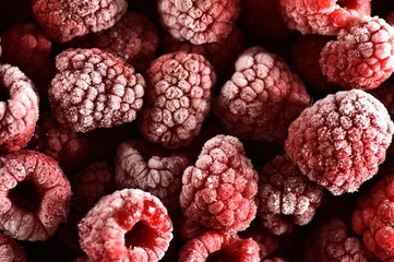 Frozen raspberries with ice coated very cold and icy