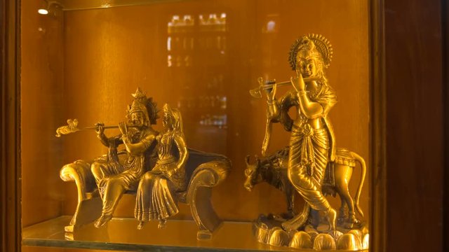Figures of traditional Indian gods are sold as souvenirs for a long memory of India. Shot in motion