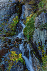 Obraz premium colorful scene of a waterfall in forest during autumn season