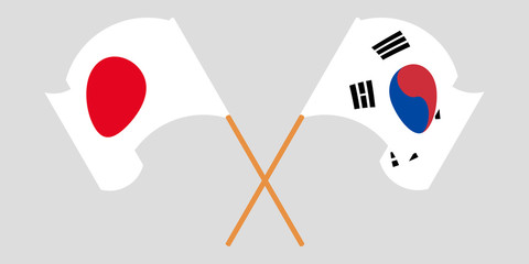 Crossed and waving flags of South Korea and Japan