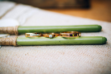 wedding rings with beautiful carvings on the sand background