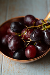 black grapes on wooden table