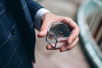 wedding rings with beautiful carvings on the sand background