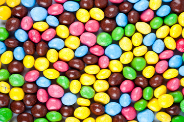 Fototapeta na wymiar Pile of delicious rainbow colorful chocolate candies background.