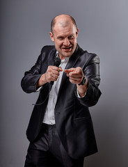 Fun emotional moving happy performer man presenting the show holding microphone in hand and showing...