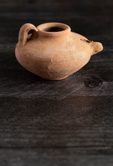 A Handmade Oil Lamp from the Middle East on a Dark Wood Table