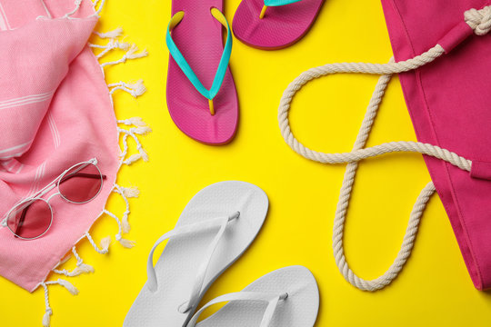 Flat lay composition with beach accessories on color background