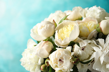 Fragrant peonies on color background, closeup with space for text. Beautiful spring flowers