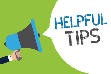 Text sign showing Helpful Tip s is. Conceptual photo Ask an Expert Solutions Hints Consulting Warning Man holding megaphone loudspeaker speech bubble message speaking loud