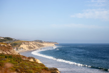 Fototapeta na wymiar sunny beach with cliff side view