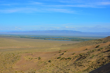 Desert landscape surrounding Singing Dune in Altyn-Emel