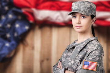Portrait of female US army soldier on flag background