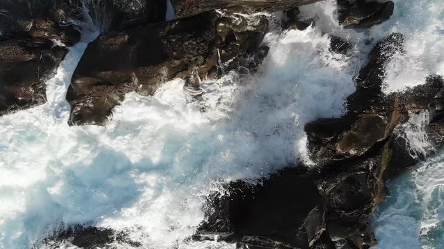 Aerial Drone Azores Portugal water flowing over rocks camera rises