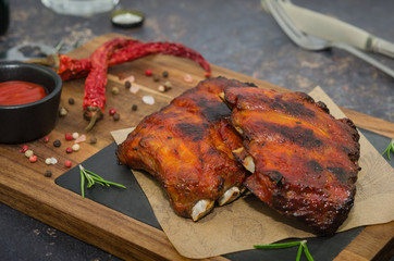 Grilled pork ribs on wooden board. Smoked barbecue pork spare ribs 